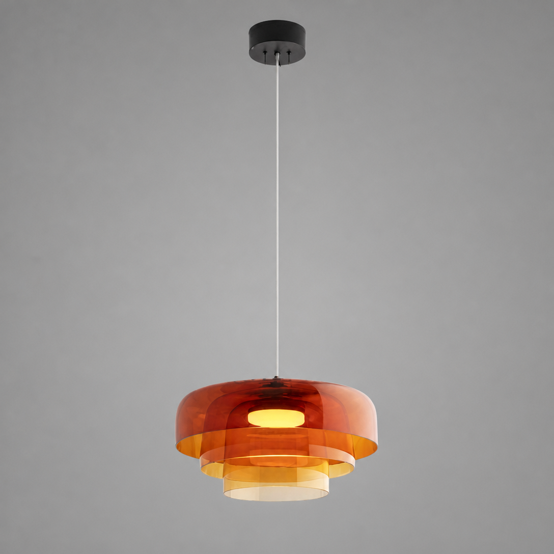 Amber art glass pendant light switched on, suspended on a white adjustable cord